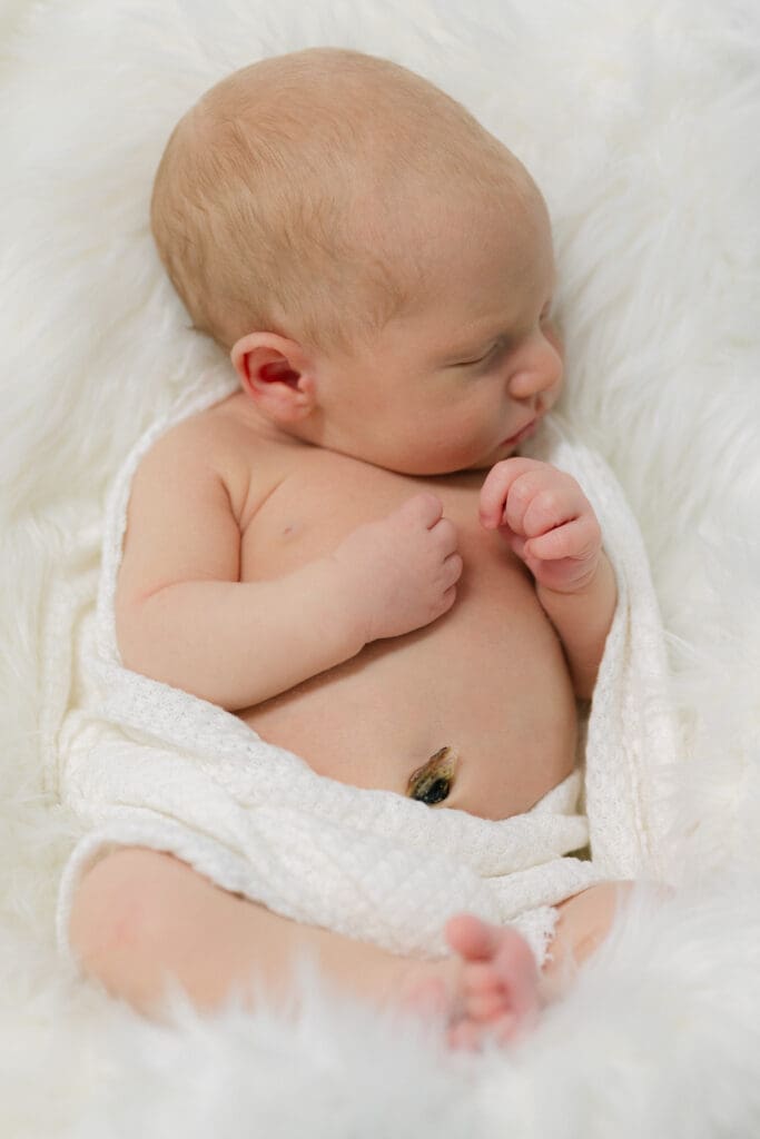 Newborn baby peacefully swaddled during a session with baby photographer in Bainbridge.