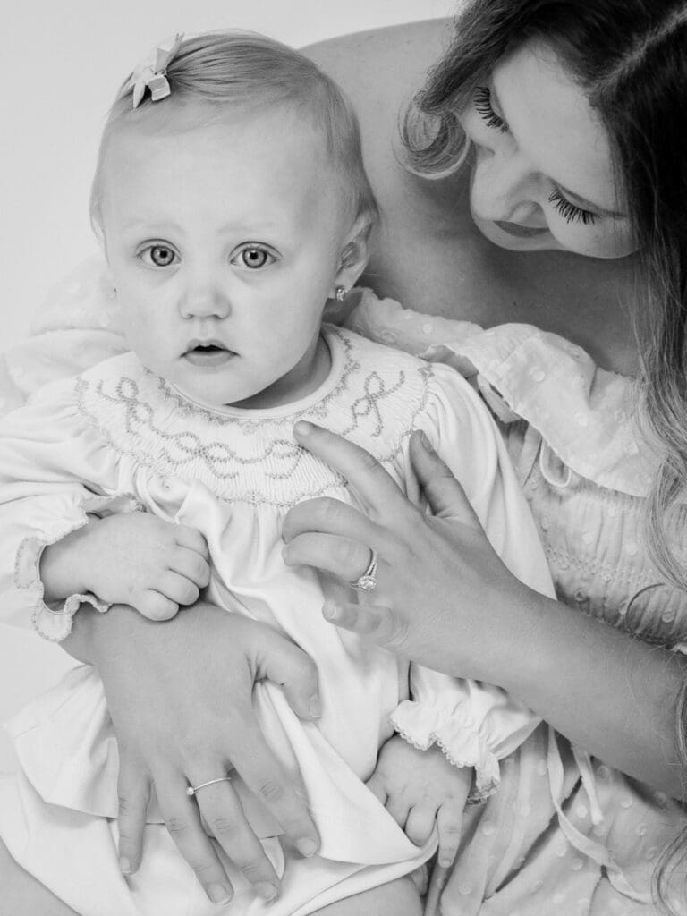 Black and white motherhood photograph of a mother holding her baby during a photography session in Bainbridge GA by Photography by LV Hughes