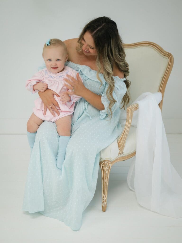 Motherhood photography session in Bainbridge GA with a mother holding her laughing baby during a studio session by Photography by LV Hughes