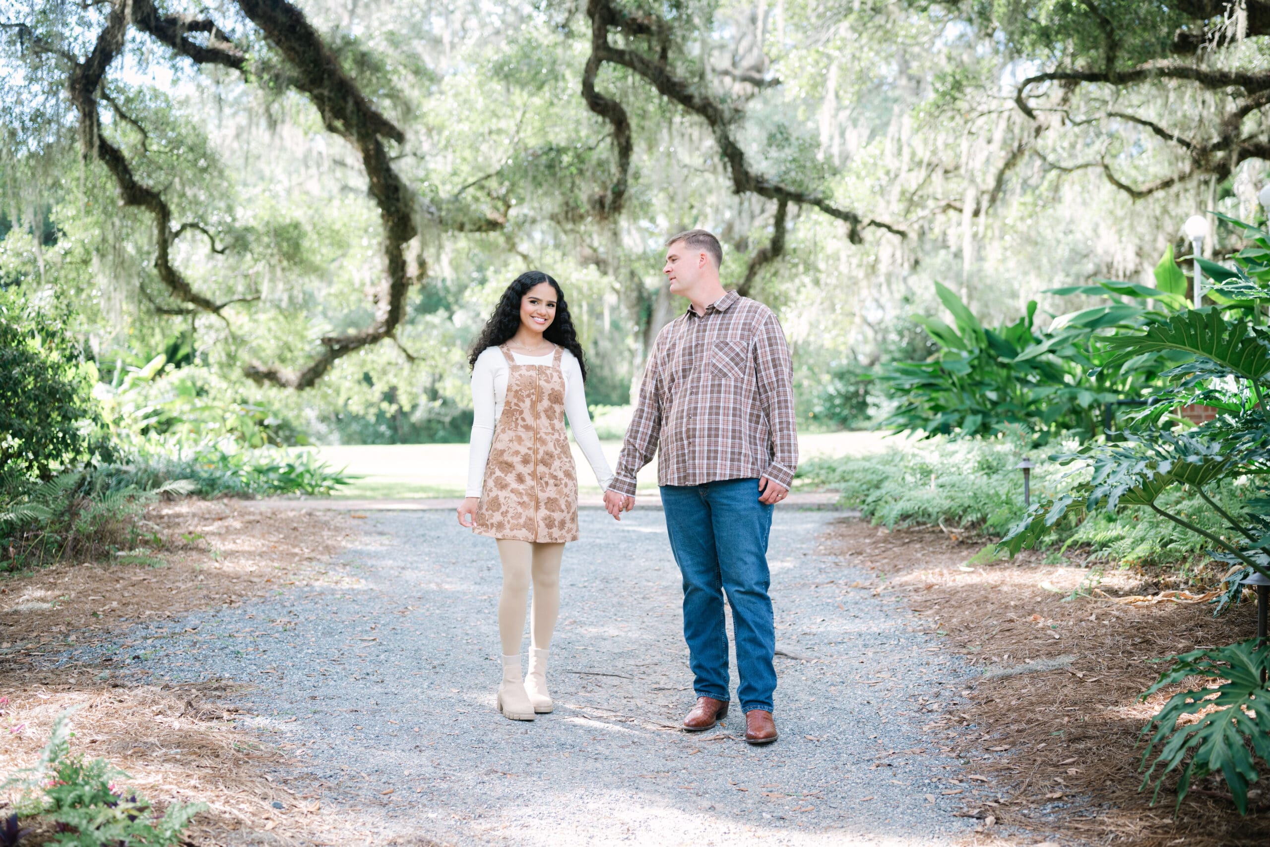 Couples photography in Tallahassee, FL, walking hand in hand during a morning session.