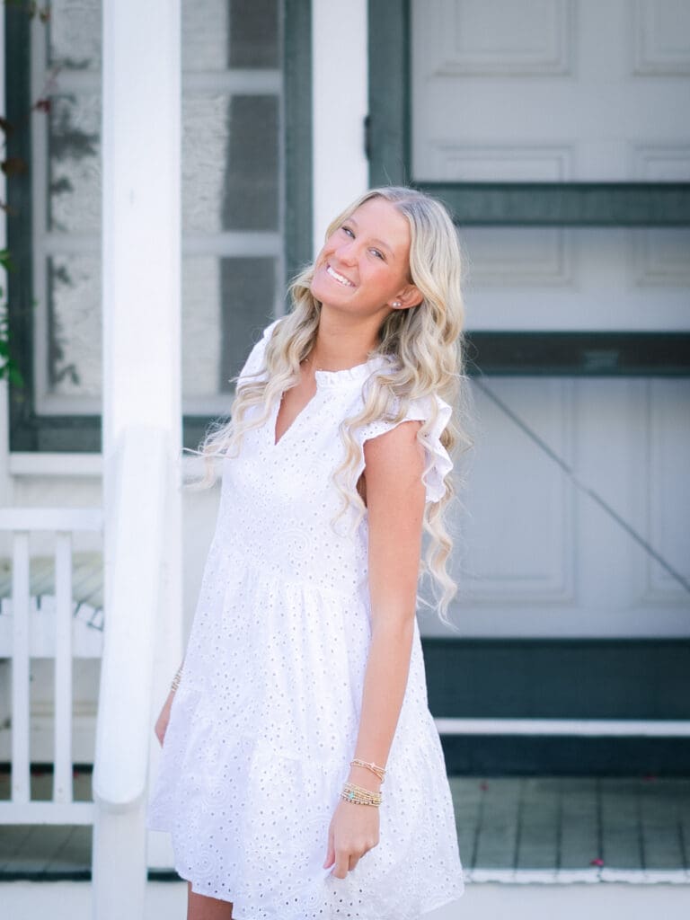 Senior girl smiling during a playful senior photography session in Bainbridge