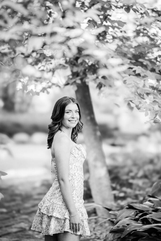 Black and white senior portrait in Bainbridge GA garden session showing girl turning around