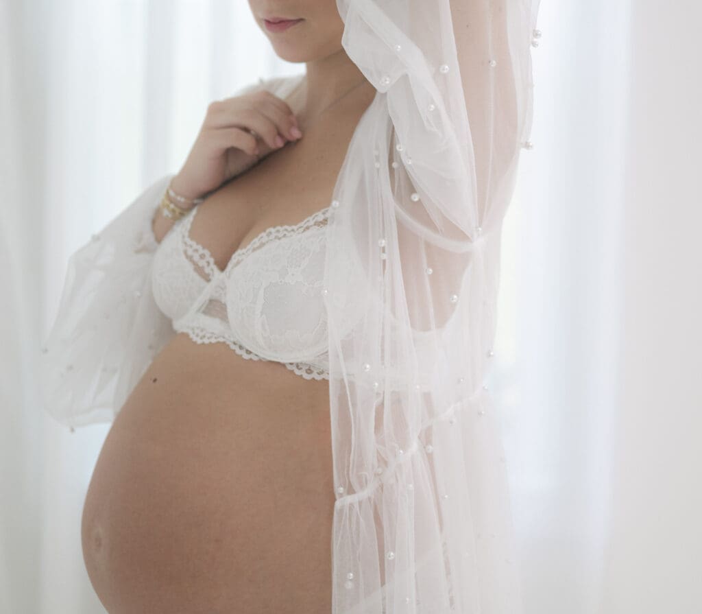 Expecting mother with her hair lifted during an intimate maternity portrait session.